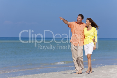 Happy Couple Walking and Pointing on A Beach