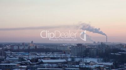Winter city at sunset in Russia with pipe and smoke