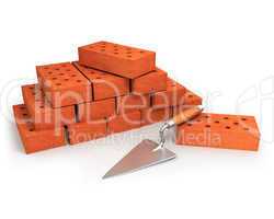 Trowel and stack of bricks isolated on white