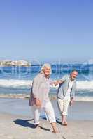 Elderly couple walking on the beach