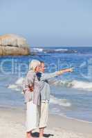 Elderly couple walking on the beach