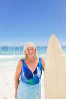 Mature woman with her surfboard