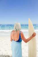 Mature woman with her surfboard
