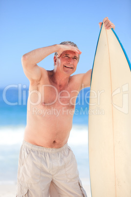 Mature man with his surfboard