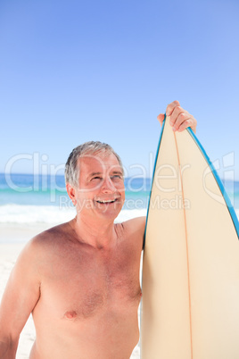 Mature man with his surfboard