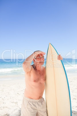 Senior man with his surfboard