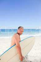 Retired man with his surfboard
