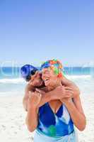 Man hugging his wife at the beach