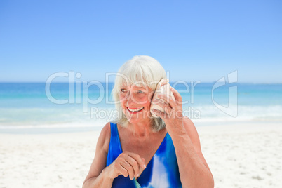 Woman listening to her shell