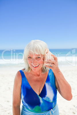 Woman listening to her shell