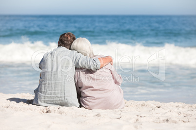 Senior couple sitting on the beach