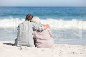 Senior couple sitting on the beach