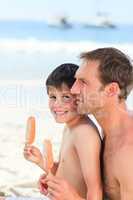 Father eating an ice cream with his son