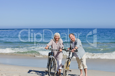 Senior couple with their bikes on the beach