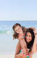 Mother playing with her daughter on the beach