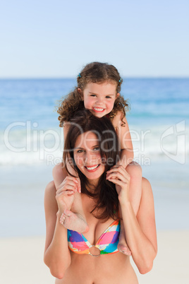 Mother playing with her daughter on the beach