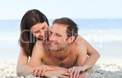 Couple lying down on the beach