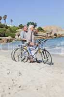 Senior couple with their bikes on the beach