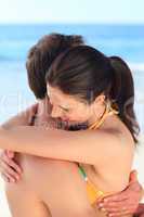 Lovely couple hugging on the beach