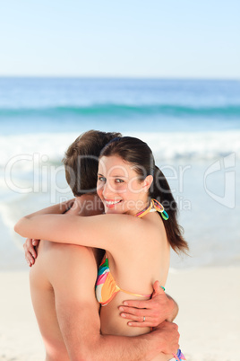 Lovely couple hugging on the beach