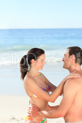 Adorable couple huging on the beach