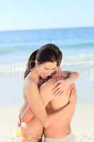 Adorable couple huging on the beach