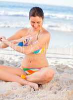 Woman applying sun cream on her skin