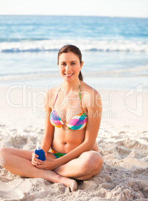 Woman applying sun cream on her skin