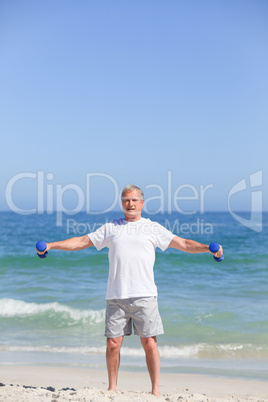 Man doing his exercises on the beach