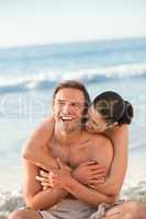 Enamored couple hugging on the beach