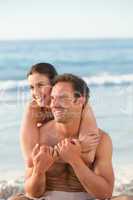 Enamored couple hugging on the beach