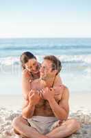 Enamored couple hugging on the beach