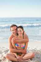 Enamored couple hugging on the beach