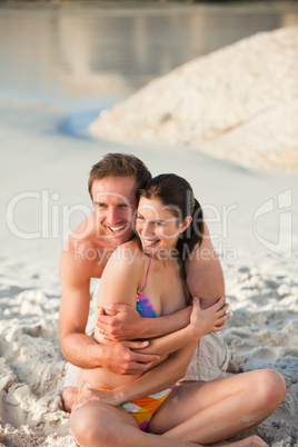 Enamored couple hugging on the beach