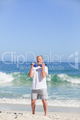 Man doing his exercises on the beach