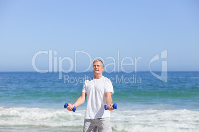 Man doing his exercises on the beach