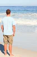 Handsome man walking on the beach