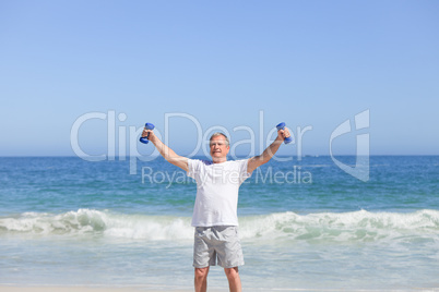 Man doing his exercises on the beach