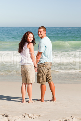 Lovers walking on the beach