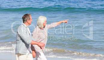 Elderly couple walking on the beach