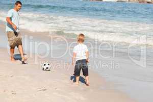 Father playing football with his son