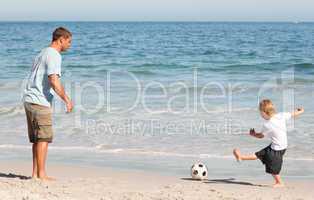 Father playing football with his son