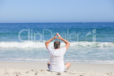 Man doing his stretches on the beach