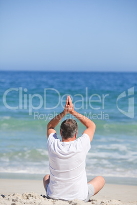 Man doing his stretches on the beach