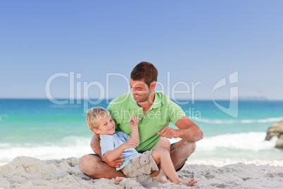 Attentive father with his son at the beach