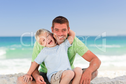 Attentive father with his son at the beach