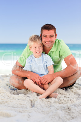 Attentive father with his son at the beach