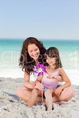 Little girl and her mother with a windmill
