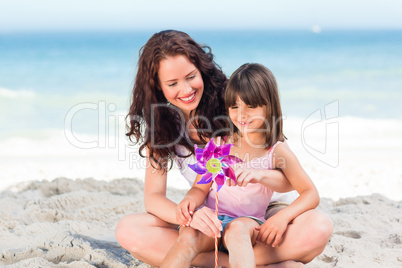 Little girl and her mother with a windmill