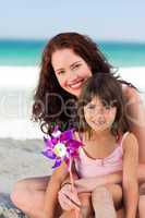 Little girl and her mother with a windmill